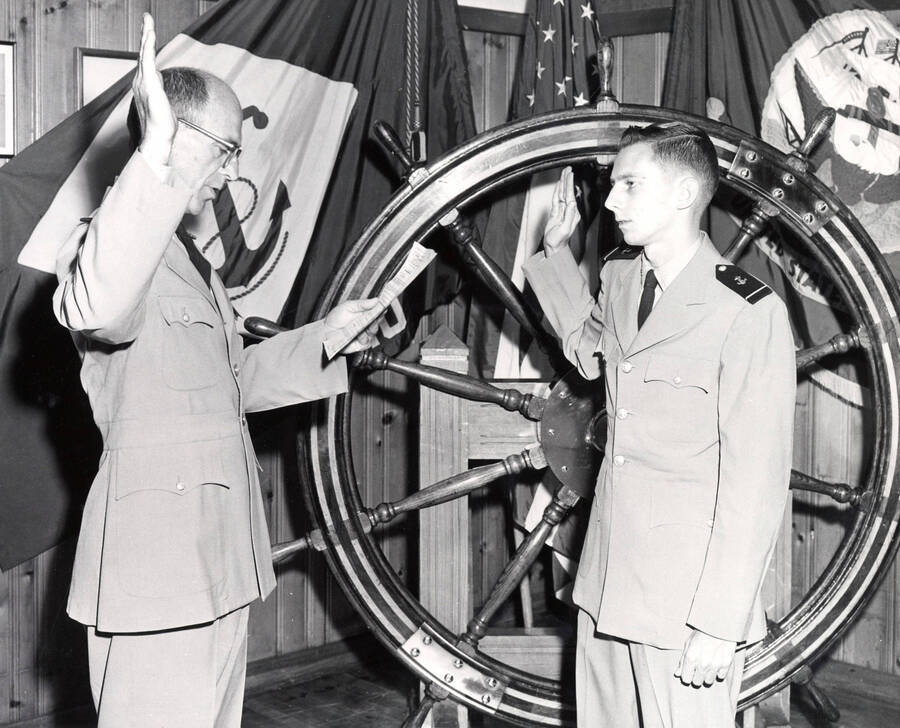 1962 photograph of Naval Science. Captain Davey commissioning Eddie Whitehead. Donor: Publications Dept. [PG1_209-10]