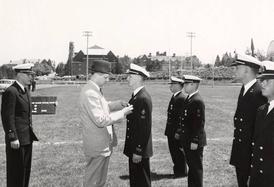 1962 photograph of Naval Science. Franklin A. Bahr receiving Naval Institute award from Dean Janssen. Donor: Publications Dept. [PG1_209-14]