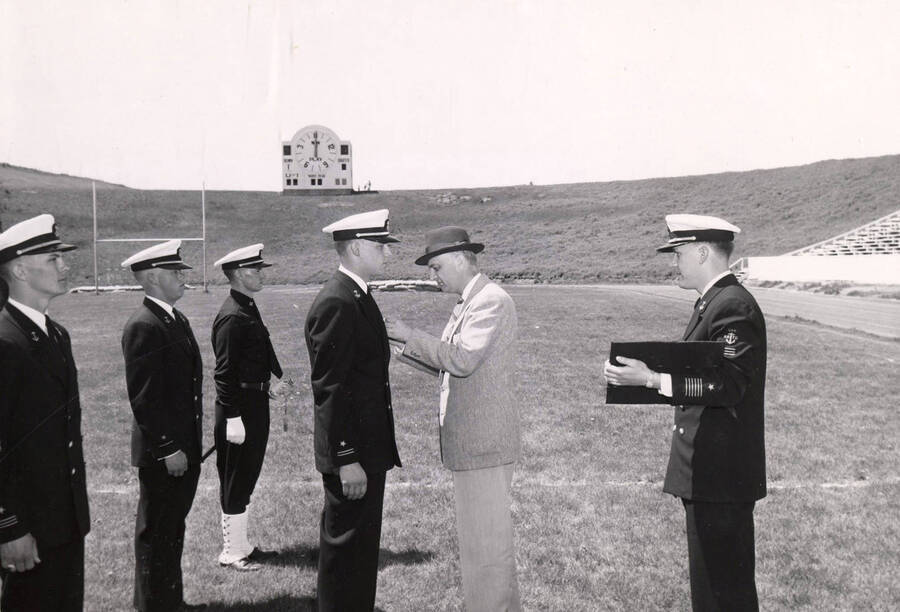 1962 photograph of Naval Science. Gordon J.A. Roberts receiving Naval Institute award from Dean Janssen. Donor: Publications Dept. [PG1_209-15]