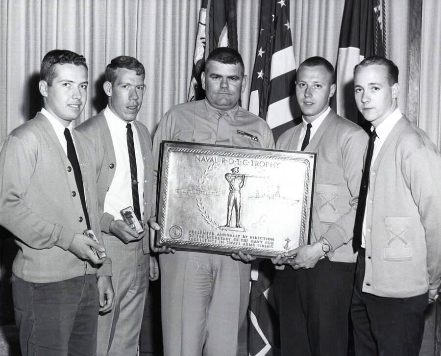 1962 photograph of Naval Science. Naval Cadets receiving the Naval ROTC trophy. Donor: Publications Dept. [PG1_209-09]