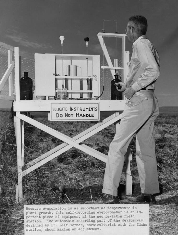 1949 photograph of Plant Sciences. Dr. Leif Verner and a self-recording evaporometer on a lab desk in a field. Donor: Publications Dept. [PG1_210-29]