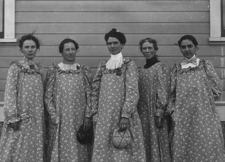 1900 photograph of Plant Sciences. Five female students outside a building. l-r: unidentified, Edith Grace Traver, Britania Daughters, Bertha Mabel Gillett, Zola A. Clark. Nitrate film. [PG1_210-09]