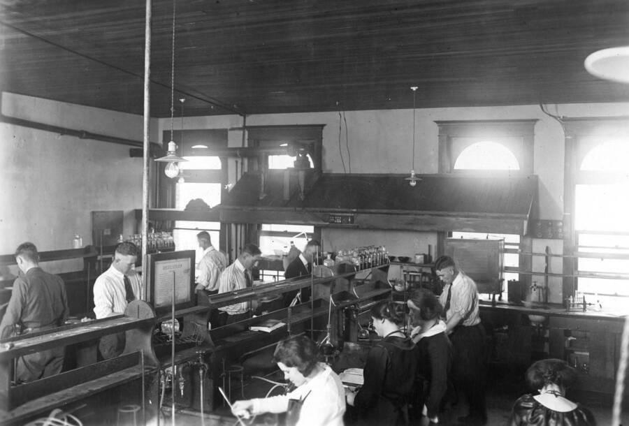 1935 photograph of Chemistry Class. Students working at laboratory tables in the chemistry lab. [PG1_211-01]