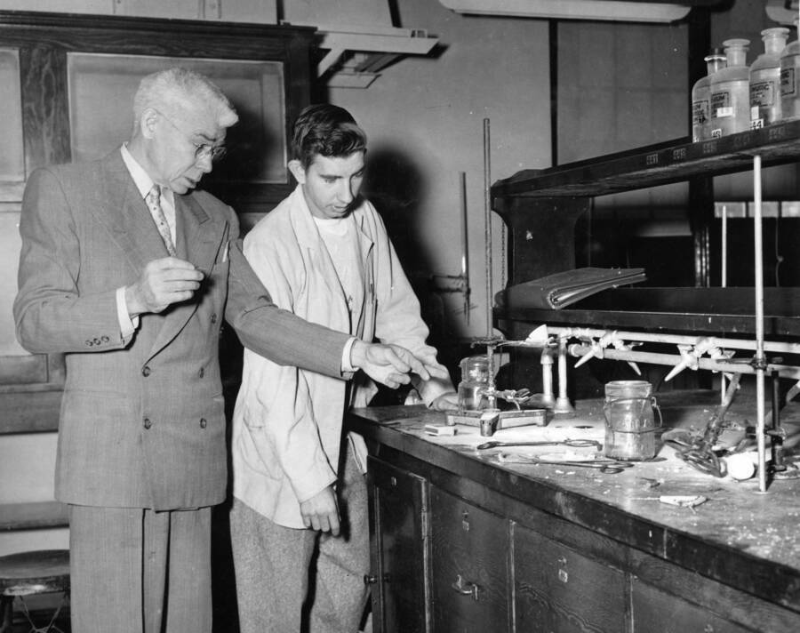 1952 photograph of Chemistry Class. William H. Cone, Hisel. Examine the scene of an explosion. [PG1_211-11]