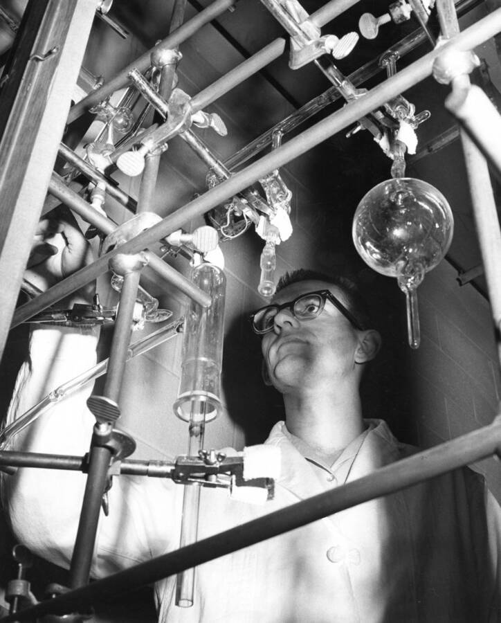 1968 photograph of Chemistry Class. Floyd Kelly operates an experimental apparatus. [PG1_211-16]
