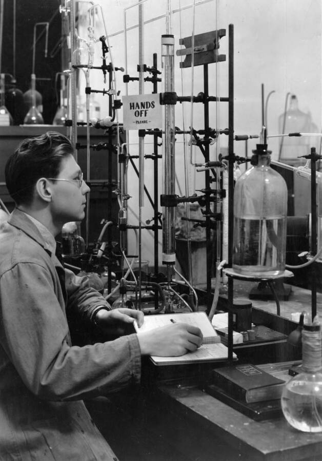 1934-12-04 photograph of Chemistry Class. Louis S. Keyser recording information from lab equipment. Nitrate film. [PG1_211-05]