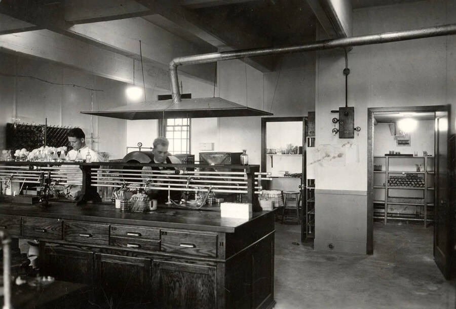 1926 photograph of Bacteriology building. Two students work in the lab. [PG1_212_02]