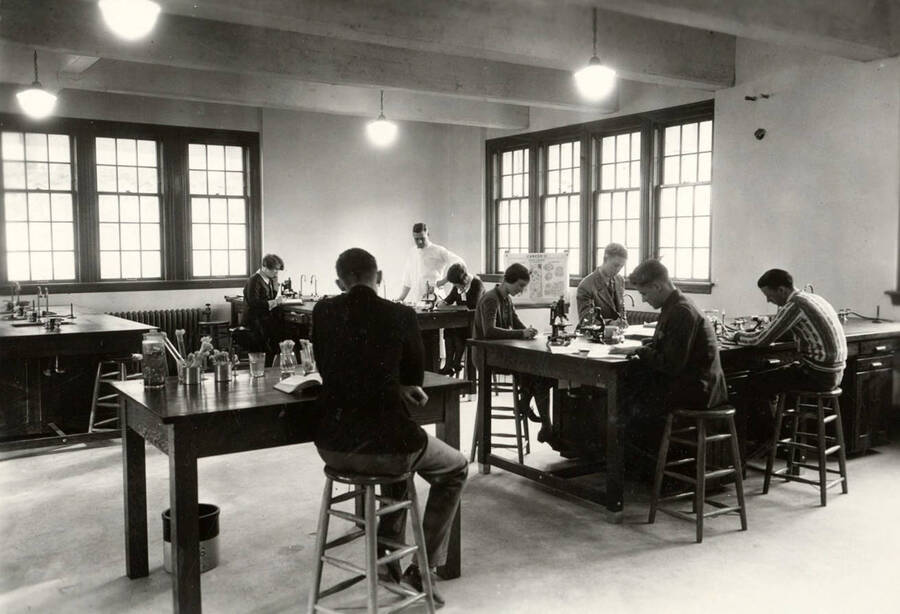 1933 photograph of Bacteriology building. Students work at their workstations in the lab. [PG1_212_03]