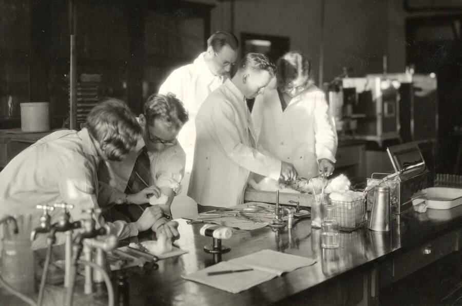 1933 photograph of Bacteriology building. Professor and students work in the lab. [PG1_212_04]