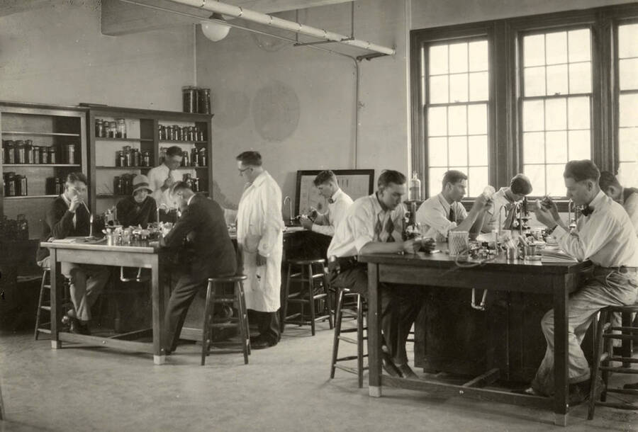 1933 photograph of Bacteriology building. Professor and students work in the lab. [PG1_212_07]