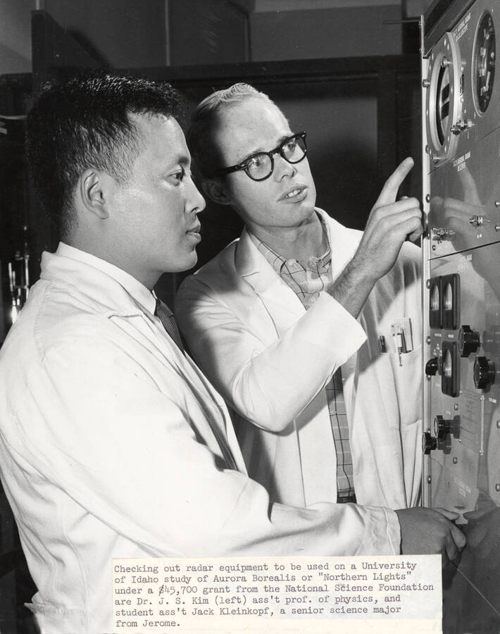 1960 photograph of Physics building. Professor and student check out the equipment. [PG1_213_04]