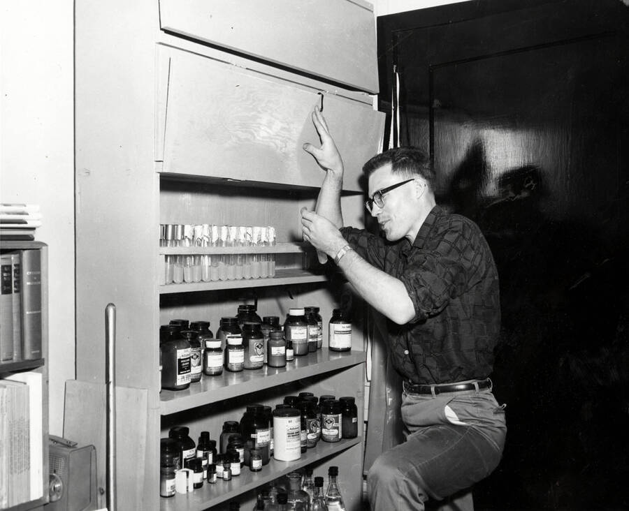 1961 photograph of Botany building. Don Fosket checks out supplies in the lab. [PG1_215_09]