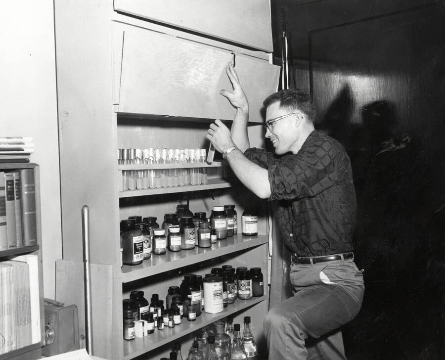 1961 photograph of Botany building. Don Fosket checks out supplies in the lab. [PG1_215_10]
