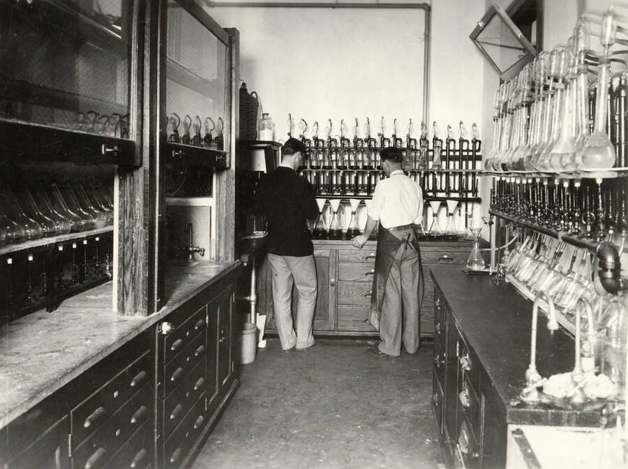1928 photograph of Agricultural chemistry building. Students check out lab supplies. [PG1_216_02]
