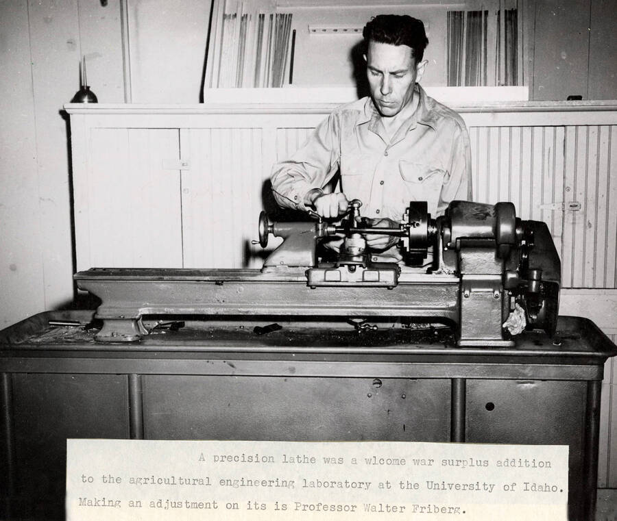 1947 photograph of Agricultural engineering building. Professor adjusts a precision lathe in the engineering lab. [PG1_217_08]