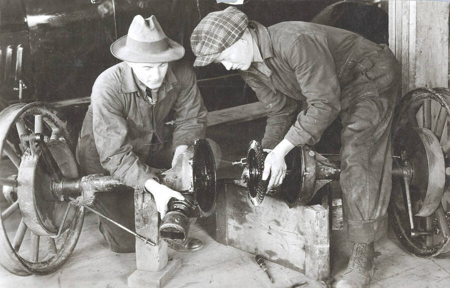 Agricultural engineering shop. University of Idaho. Students working on axle. [217-3]