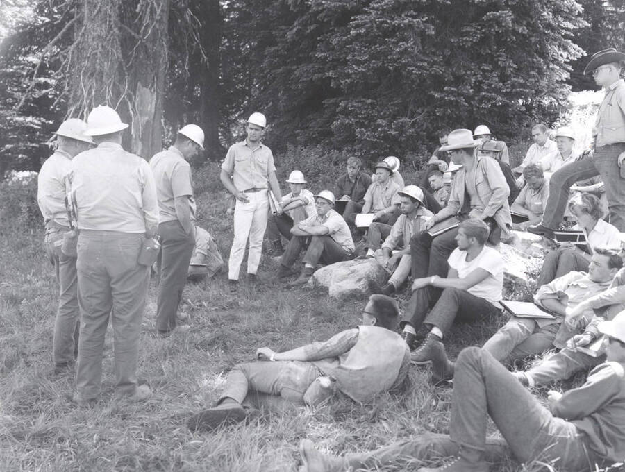 1966 photograph of College of Forestry. Students sitting on a hillside during the forestry summer camp. Also print. Donor: Fred Johnson. [PG1_218-69e]
