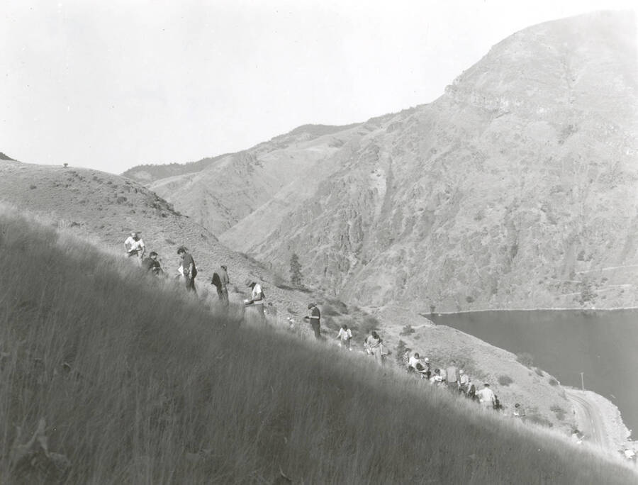 1968 photograph of College of Forestry. Students stand on a hillside overlooking a lake during the forestry summer camp. Also print. Donor: Fred Johnson. [PG1_218-70c]