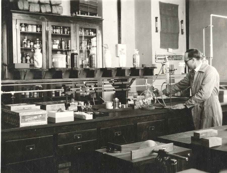 1930 photograph of College of Forestry. Dr. Hubert at a lab table in the Forestry Laboratory. [PG1_218-01]