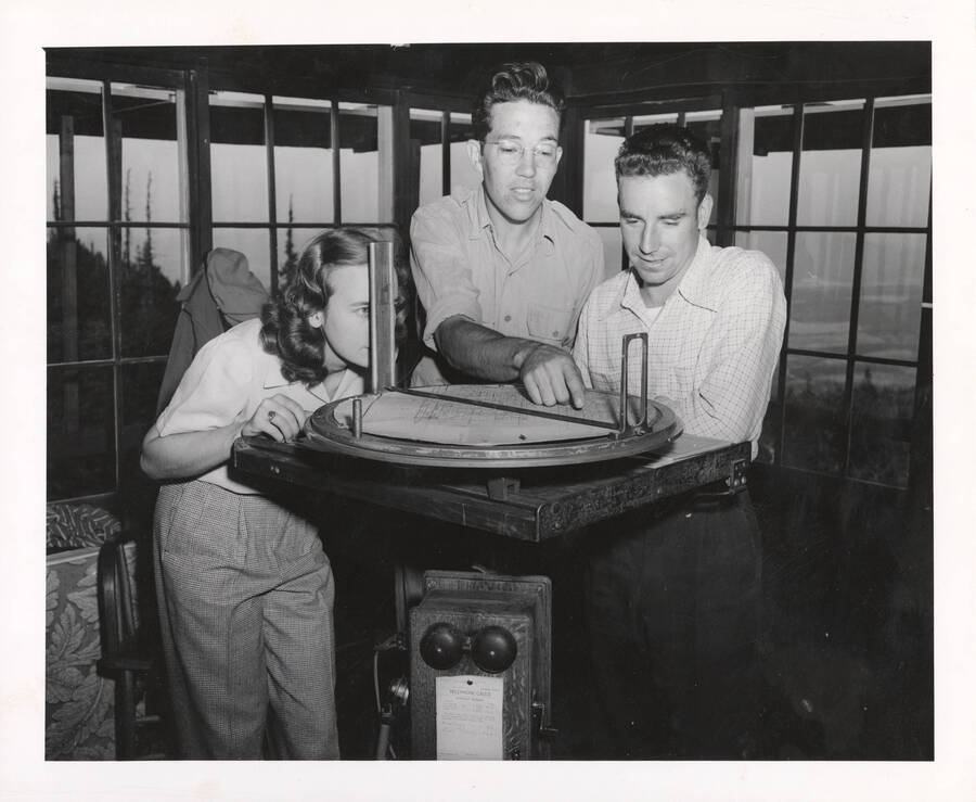 1940 photograph of College of Forestry. Students taking readings in a fire lookout. [PG1_218-18]