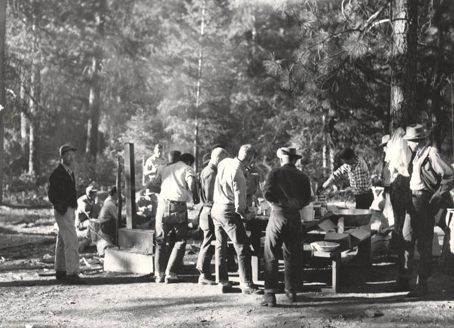 1952 photograph of College of Forestry. Students lined up at the chow line during the Forestry summer camp. [PG1_218-21]