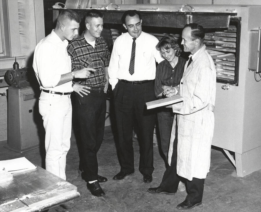 1960 photograph of College of Forestry. John Howe, professor of wood utilization, with four students. Donor: Publications Dept. [PG1_218-37]