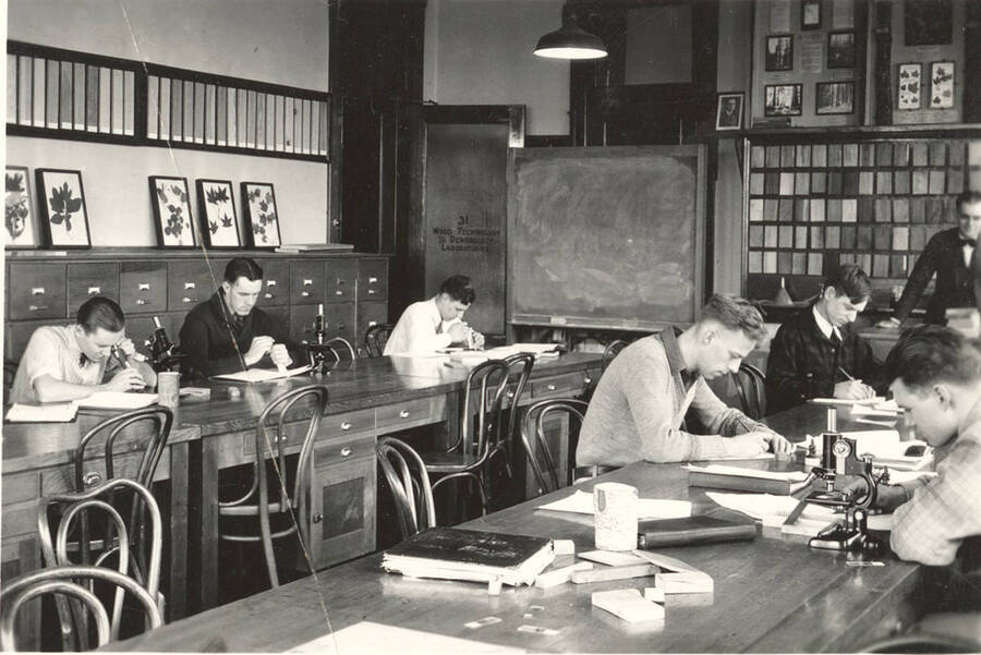 1928 photograph of College of Forestry. Students studying during wood technology class. [PG1_218-04]
