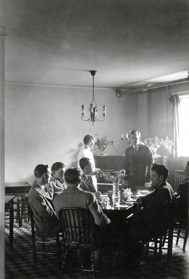 1925 photograph of Home Economics. Students at a table during the senior demonstration dinner. [PG1_221-015]