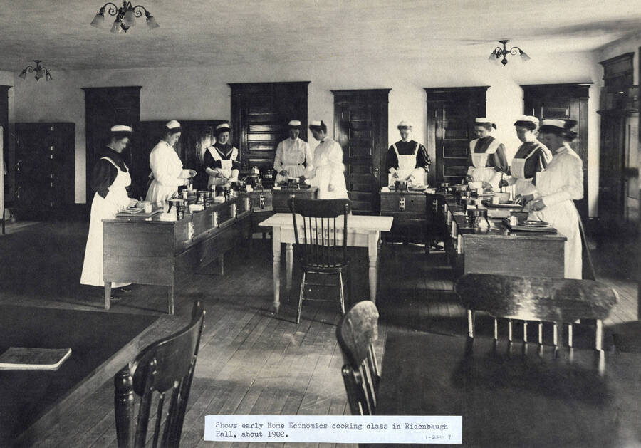 1902 photograph of Home Economics. Students cooking for class in Ridenbaugh Hall. [PG1_221-017]