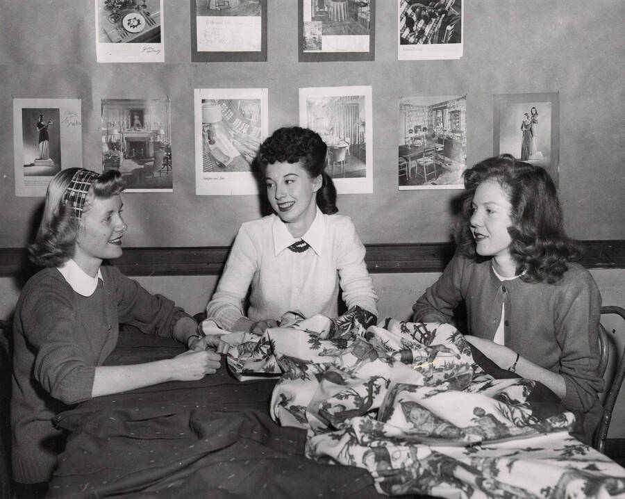 1945 photograph of Home Economics. Students around a table covered in cloth. [PG1_221-021]