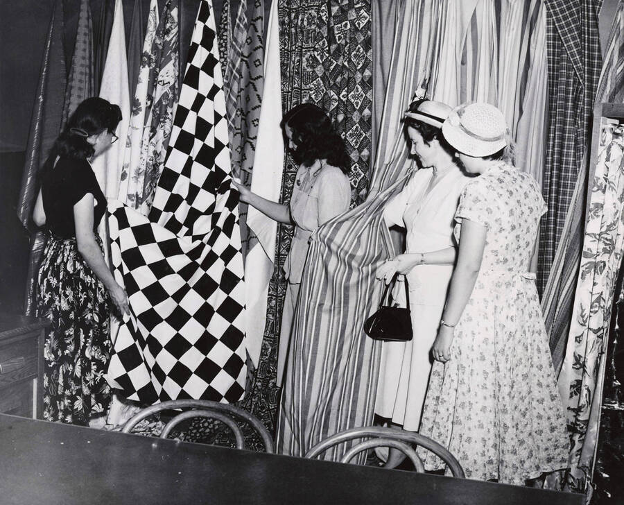 1945 photograph of Home Economics. Students examining drapery samples. [PG1_221-022]