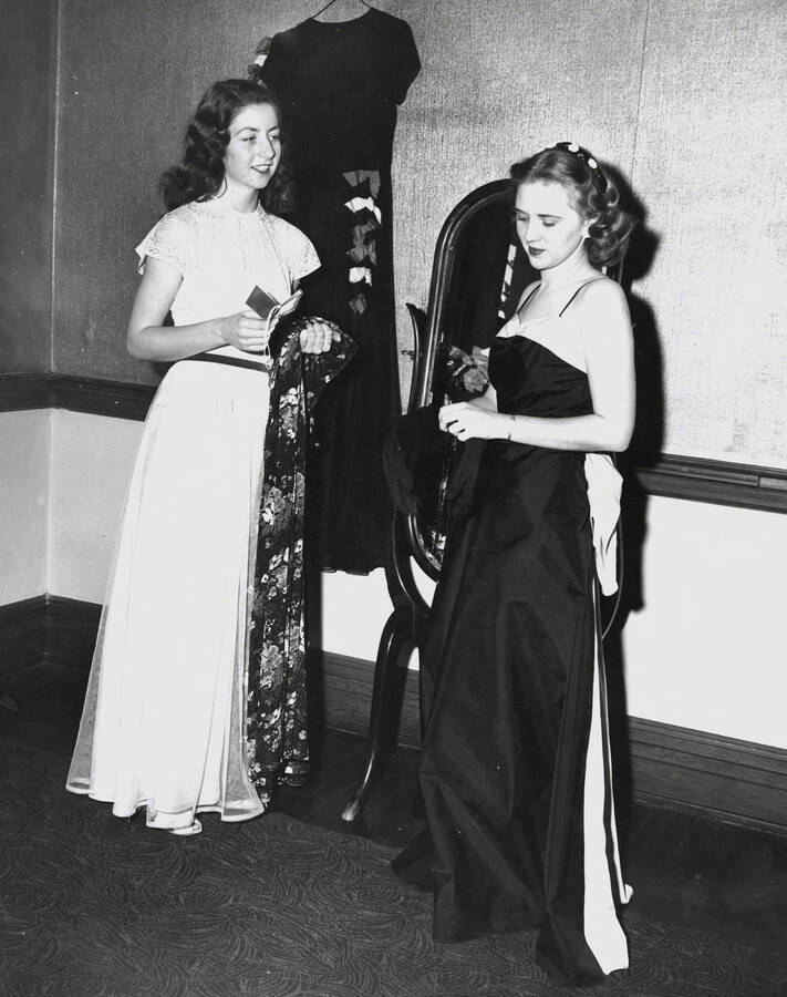 1945 photograph of Home Economics. Two students modeling dresses at a fashion show. [PG1_221-029]