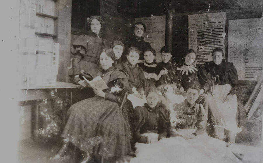 1904 photograph of Home Economics. Students sitting in the Home Economics classroom. [PG1_221-032]