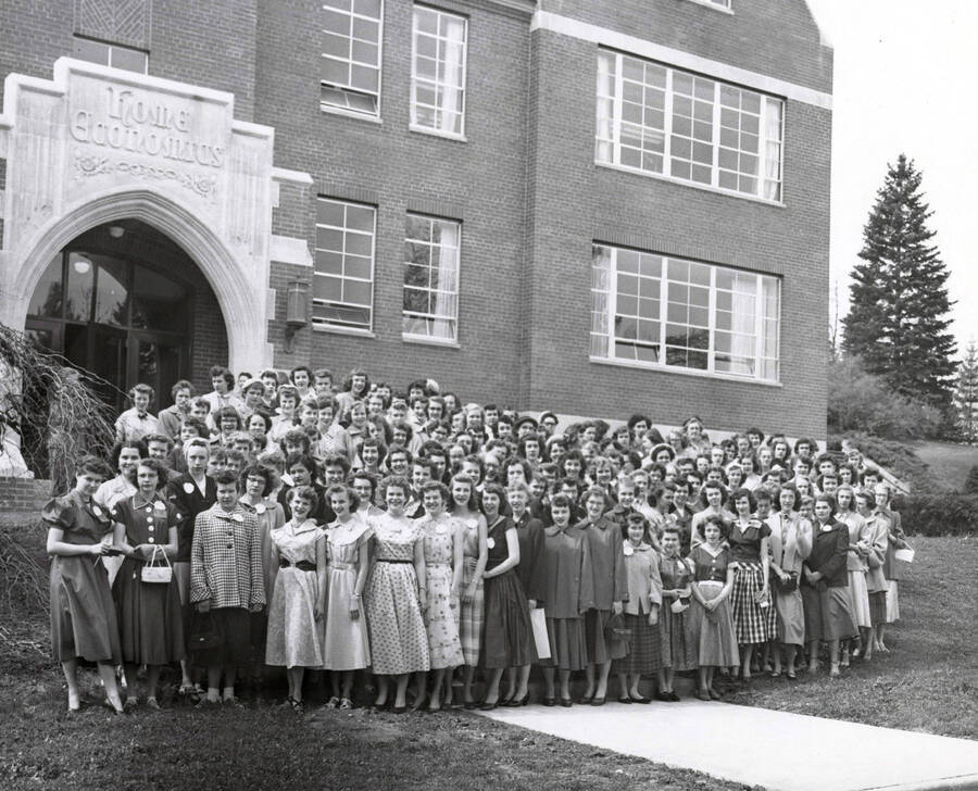 1950 photograph of Home Economics. Students outside Home Economics building. Donor: Publications Dept. [PG1_221-036]