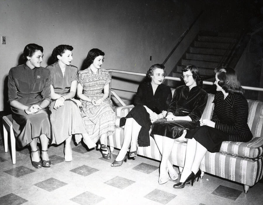 1940 photograph of Home Economics. Students sitting on a landing above a stairwell in the Home Economics building. Donor: Publications Dept. [PG1_221-039]