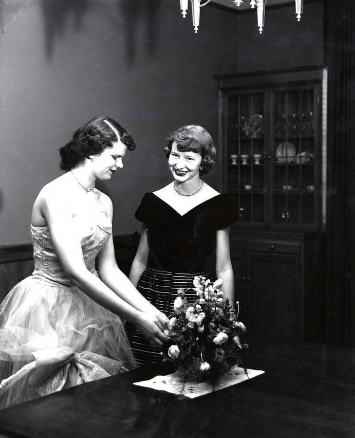 1950 photograph of Home Economics Unidentified student and Patricia Stewart arranging flowers. Donor: Publications Dept. [PG1_221-041]