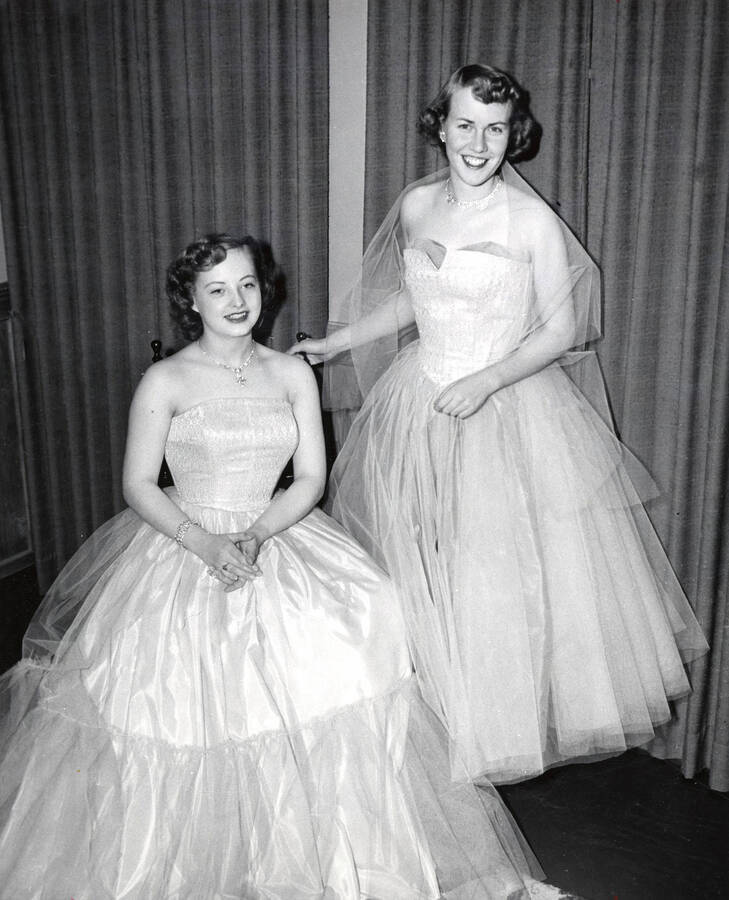 1955 photograph of Home Economics. Theresa Matthieson and Shirley Lenz model formal dresses they designed, wove, and made Donor: Publications Dept. [PG1_221-046]