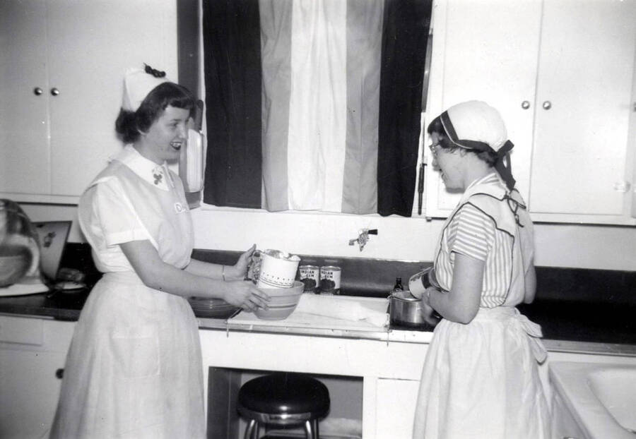 1956 photograph of Home Economics. Jane Scheline and Sharron Scheline 4-H cherry pie baking contest winners. Donor: Publications Dept. [PG1_221-060]