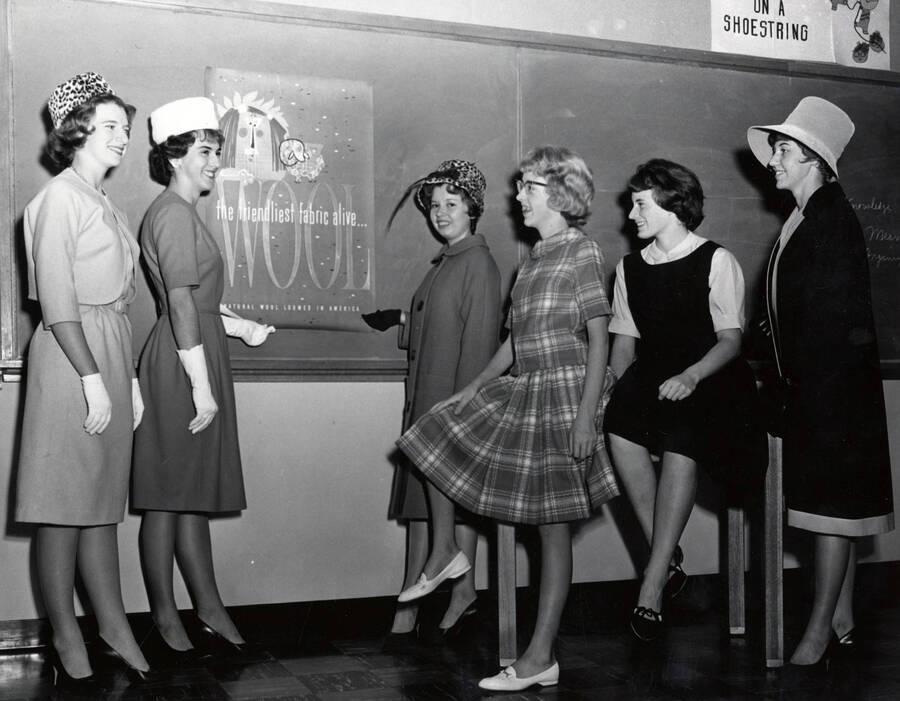 1962 photograph of Home Economics. Students modeling wool dresses. Donor: Publications Dept. [PG1_221-071]