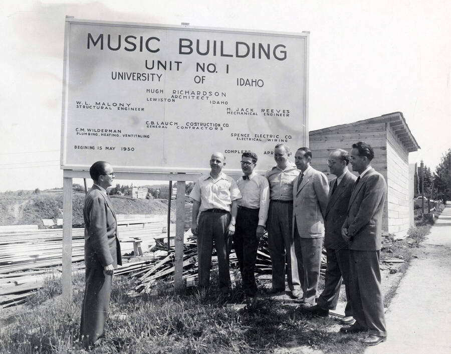 1950 photograph of Music Department. Staff members Macklin, Schwartz, Mattos, Yoder, Wayne Hertz, Barr, and Snodgrass inspect the site for the new music building. [PG1_222-013]