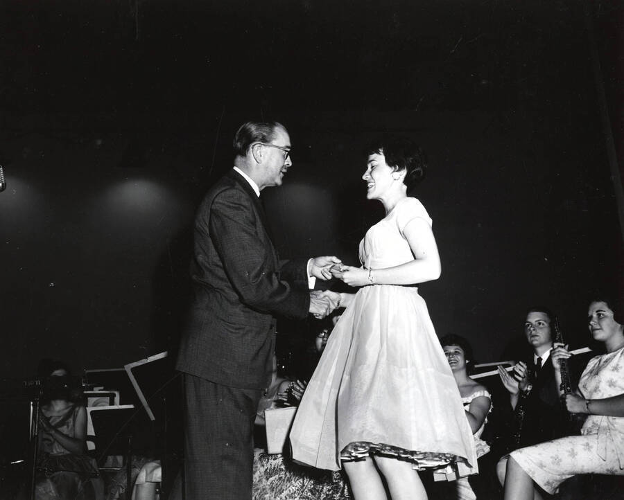 1951 photograph of Music Department. Hall Macklin presenting a summer music camp award to Camille Bastian. Donor: Publications Dept. [PG1_222-024]
