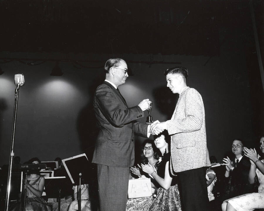 1951 photograph of Music Department. Hall Macklin presenting a summer music camp award to George Davidson. Donor: Publications Dept. [PG1_222-025]