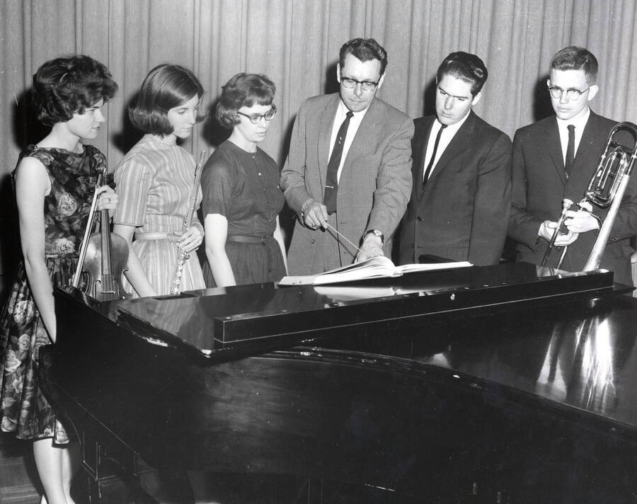 1961 photograph of Music Department. Gay R. Silha, Pat Cannon, Angela Sherbenou, LeRoy Bauer (conductor), James Schoepflin, Harry Betts. Donor: Publications Dept. [PG1_222-028]