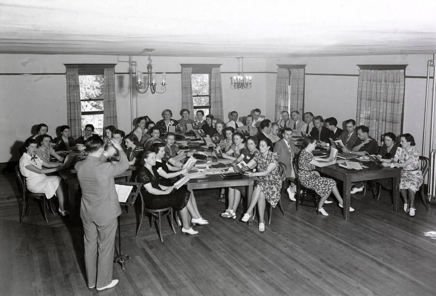1938 photograph of Music Department. D. Sterling Wheelwright instructs a classroom of students. [PG1_222-003]