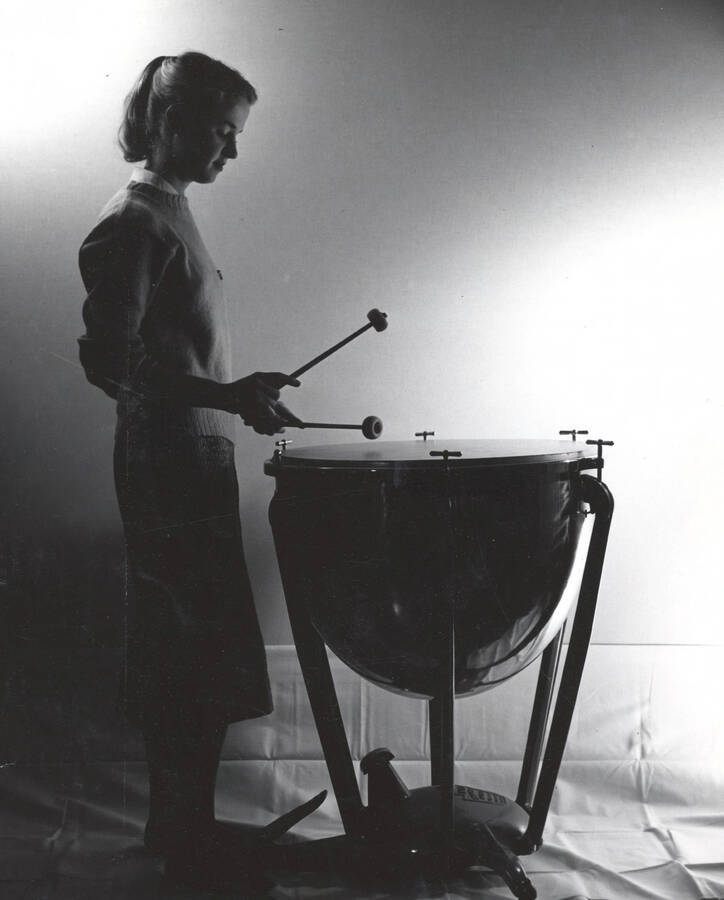 1964 photograph of Music Department. A female student plays a timpani. Donor: Publications Dept. [PG1_222-034]