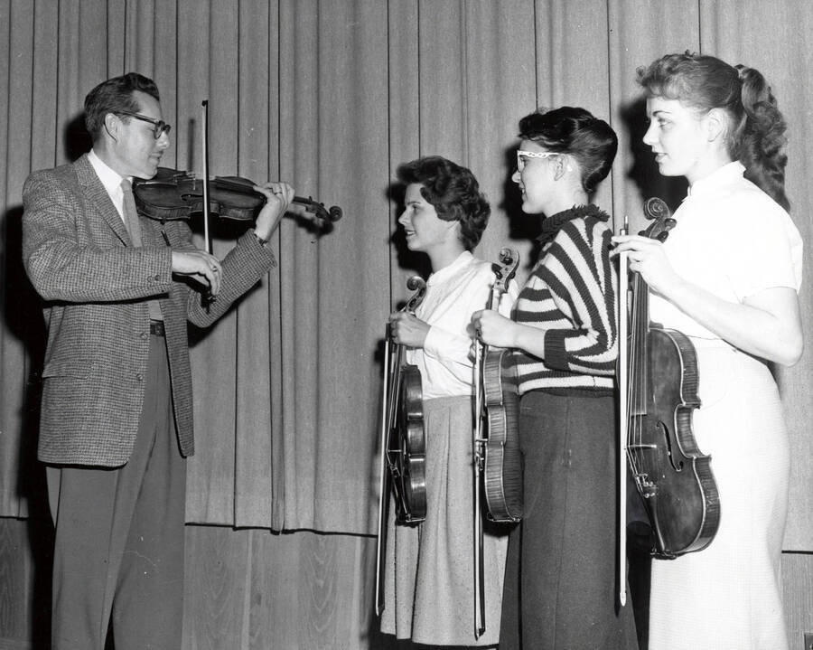 1961 photograph of Music Department. LeRoy Bauer with violin students. Donor: Publications Dept. [PG1_222-041]