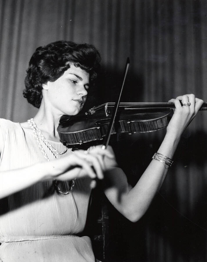 1955 photograph of Music Department. Violin soloist Gay R. Silha perfoming. Donor: Publications Dept. [PG1_222-042]