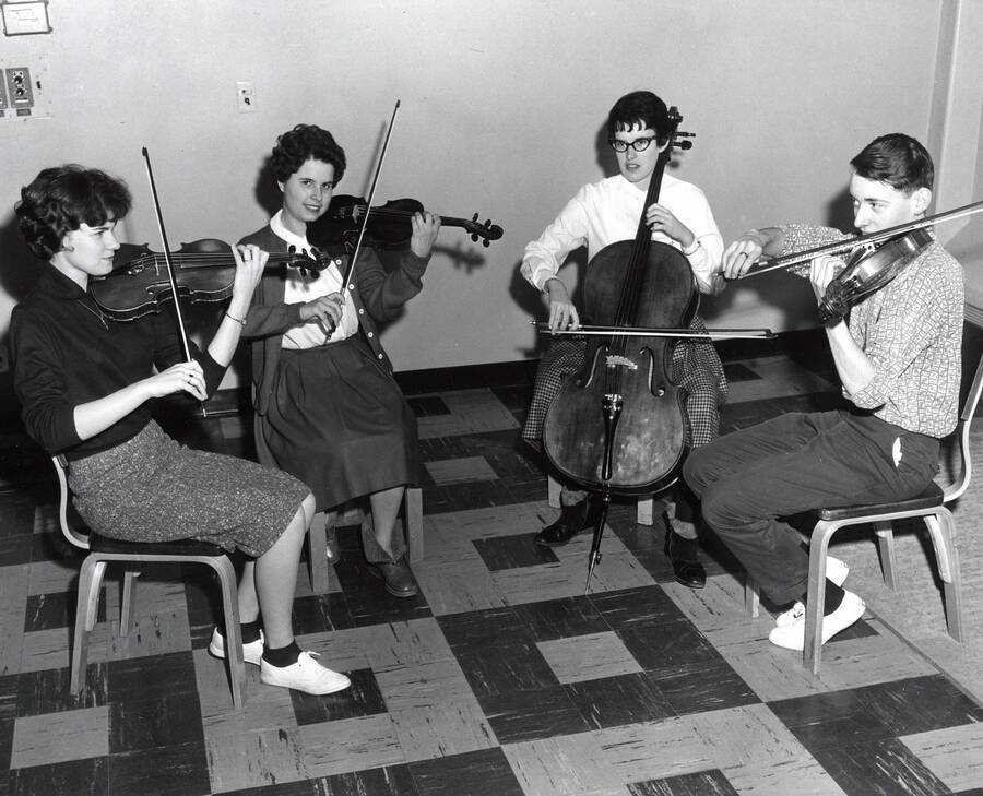 1954 photograph of Music Department. Student string quartet practicing. Donor: Publications Dept. [PG1_222-043]