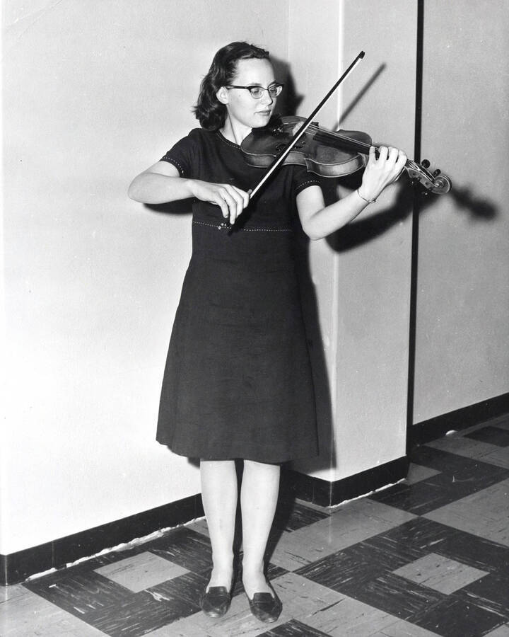 1955 photograph of Music Department. Violinist practicing. Donor: Publications Dept. [PG1_222-046]