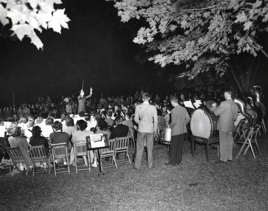 1945 photograph of Music Department. Summer school band performs during a night concert. [PG1_222-005]